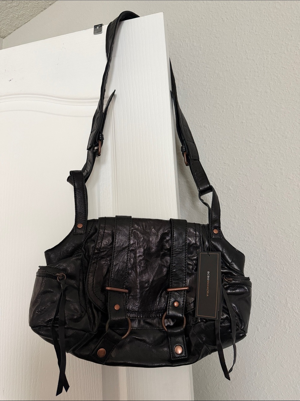 New BCBGMaxAzria Black Leather Shoulder Bag with Brushed Metal Accents.